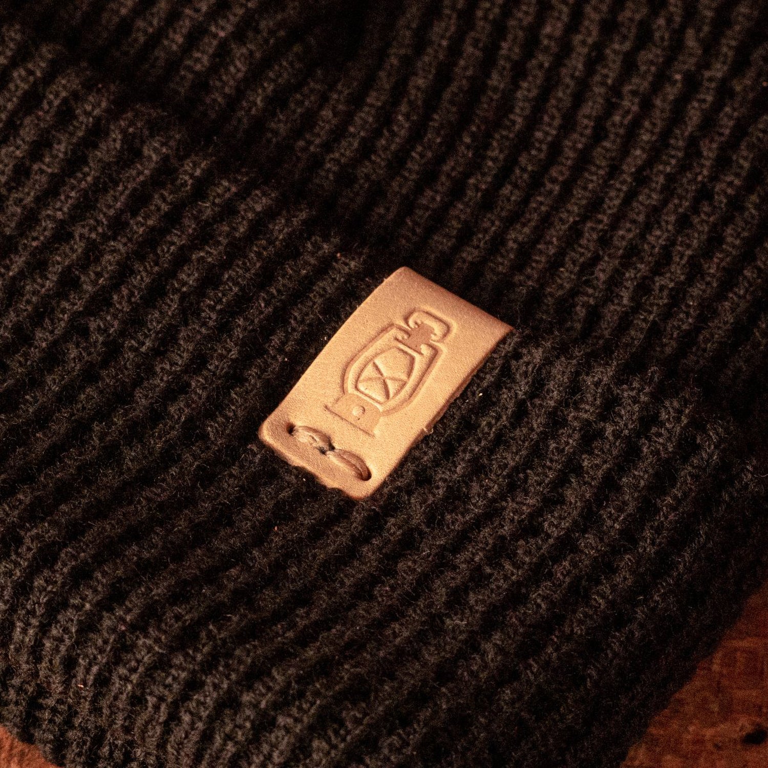 Leather logo detail on the Waffle Knit Watch Cap by Dark Forest