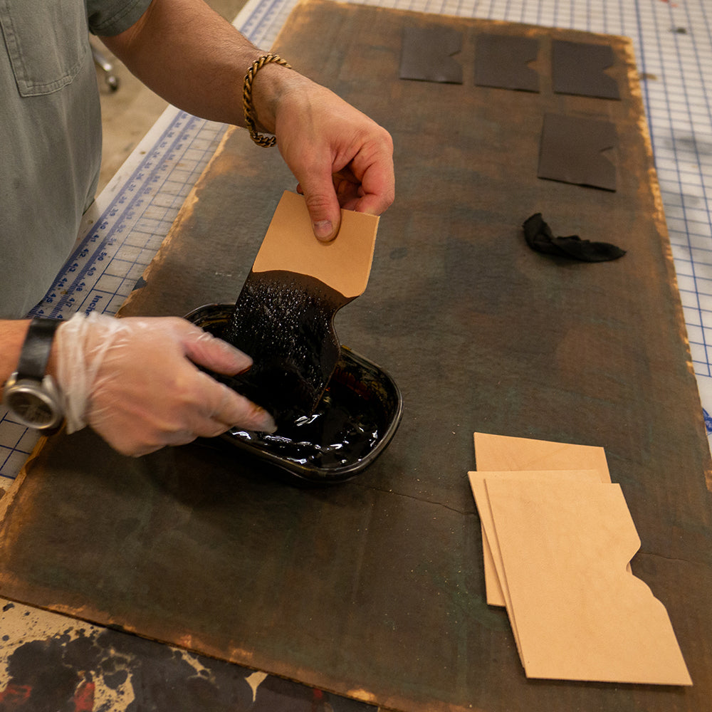 Leather being dyed before wallet assembly by Dark Forest